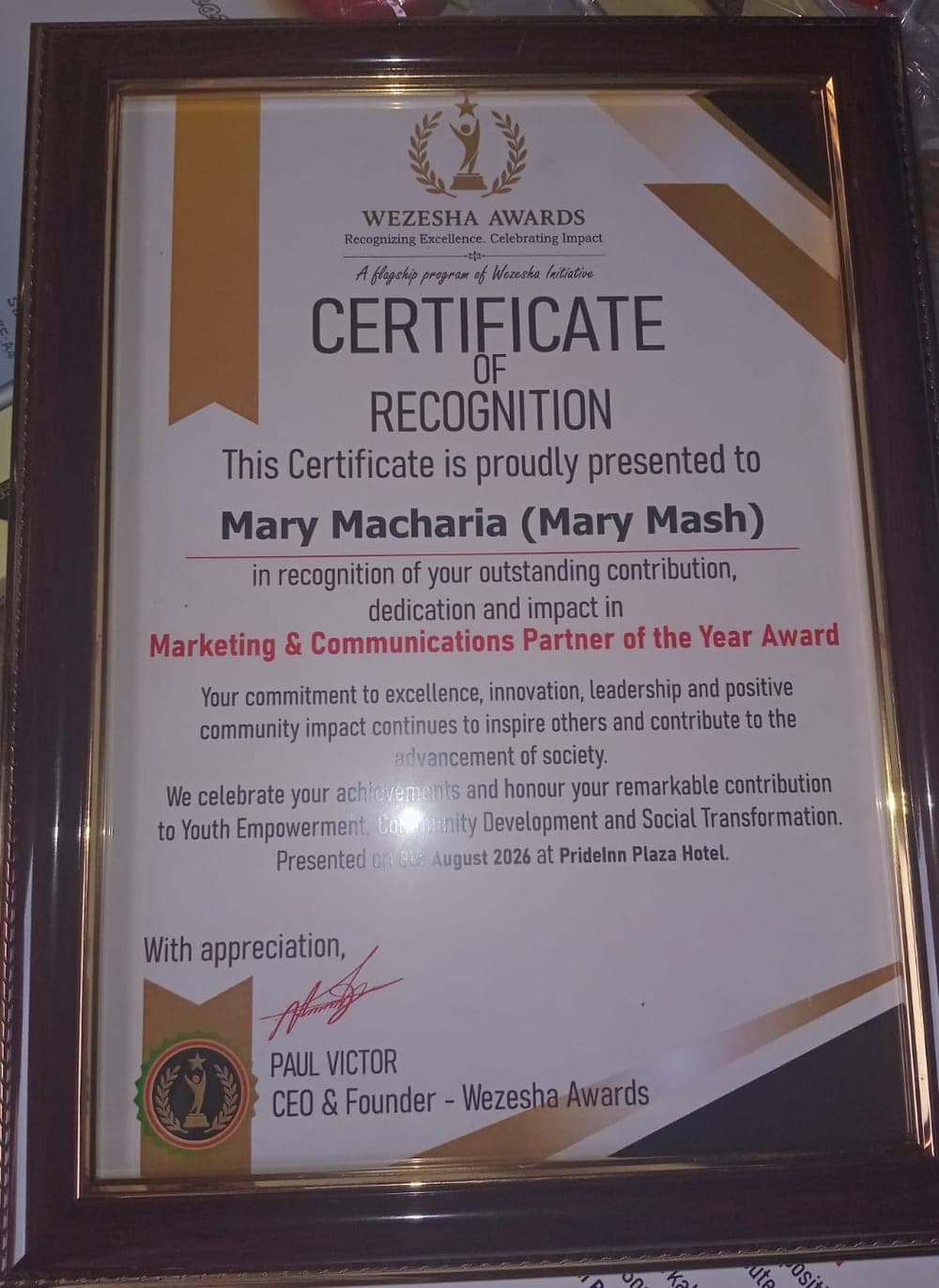 Framed Wezesha Awards certificate naming Mary Macharia Marketing & Communications Partner of the Year
