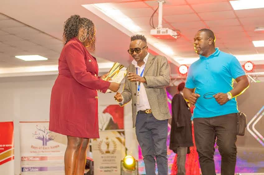 An award being handed over on stage at the Wezesha Awards 2026